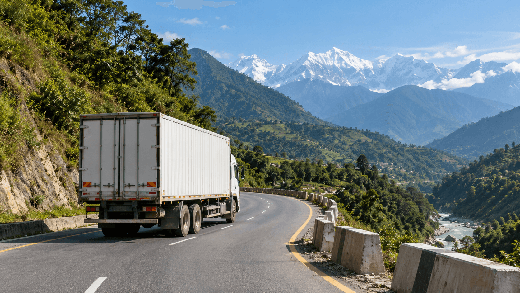 Commercial freight truck on a maintained Himalayan trade road with protected cargo